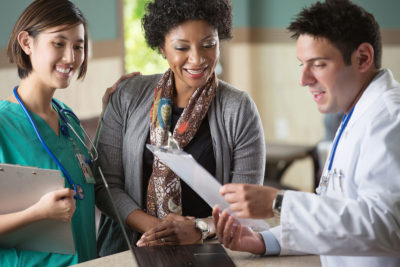 A female nurse, African-American mother, and clinician talking