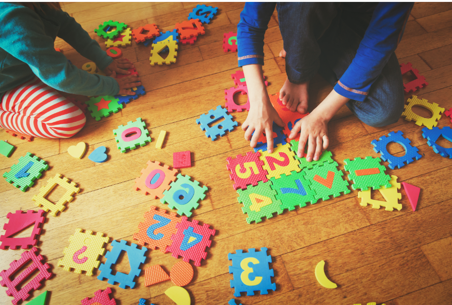 Kids putting together a puzzle. 