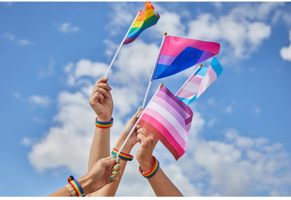 Colorful flags being held up in sign of unity. 